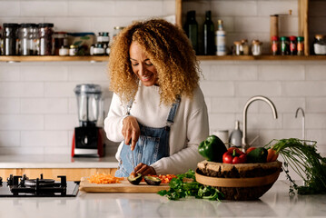 Woman preparing food in kitchen.