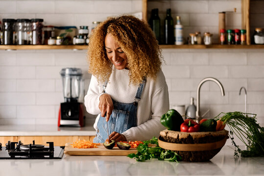 Woman preparing food in kitchen.