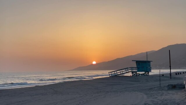 Beautiful Zuma Beach sunset with the lifeguard station in the foreground, Malibu, California