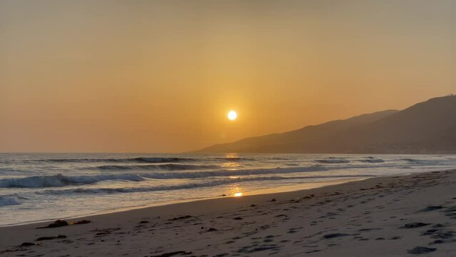 Beautiful Zuma Beach sunset with the lifeguard station in the foreground, Malibu, California