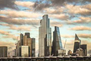 Fototapeta na wymiar Cityscape of big buildings in London, on a cloudy day at the sunset.