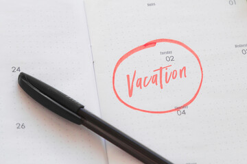 calendar planner notebook with vacation date marked and circled with marker