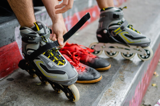 close up of rollers being tied up by an unrecognizable young man