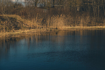 pond with steep shores in the spring