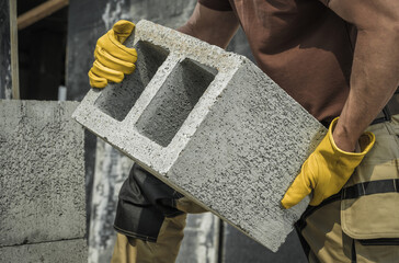 Fototapeta Construction Worker Moving Hollow Dense Concrete Blocks obraz