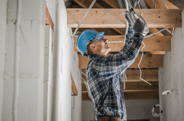 Professional Electrician Installing Ceiling Light Point - 502471996