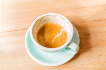 Almost drunk cappuccino on almond milk. Delicious fragrant cappuccino in a blue cup.