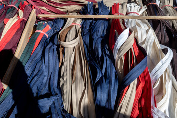 Heap bunch of fabric zippers on the outdoor market's stall. 