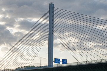 A modern bridge, silhouetted against the early morning sky, spans the Rhine River near 
cologne, Germany.