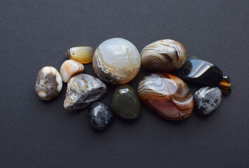 Multicolored gemstones, tumbled minerals. Agates of various sizes. Bostwan agate, druse citrine and quartz geode