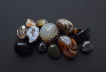 Multicolored gemstones, tumbled minerals. Agates of various sizes. Bostwan agate, druse citrine and quartz geode