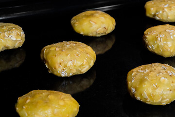 Many uncooked homemade oatmeal cookies on metal sheet in oven - close up view. Dessert, cookery,...