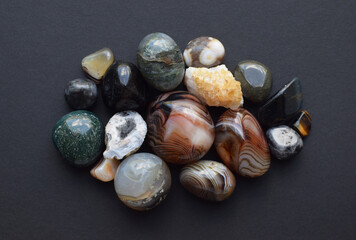 Multicolored gemstones, tumbled minerals. Agates of various sizes. Bostwan agate, druse citrine and...