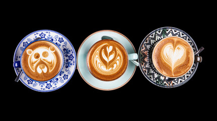 Coffee cup assortment top view collection, assortment of coffee cups with coffee art top view collection isolated on black background.