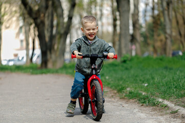boy riding a bike on the street. Learning to ride a bike concept