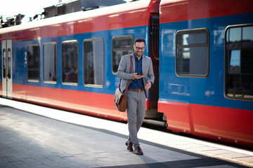 Young businessman on train station preparing for trip