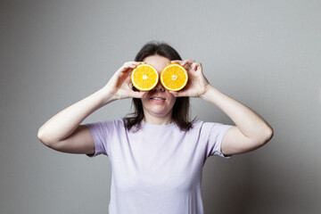 young woman holding an orange in her hand. Healthy food concept
