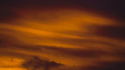 Orange Sky in the evening. Dark cloudscape, deep sunlight, dark brown weather