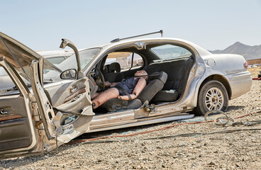 Fire Fighter demonstrating how to remove an injured person from a car