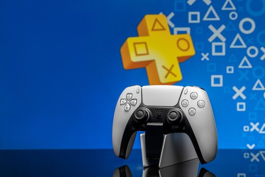 May 2, 2020, Odessa, Ukraine. White New Playstation 5 Gamepad With Playstation Plus On Screen, Selective Focus. Blue Back