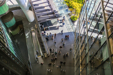 Overhead view of people walking between modern buildings