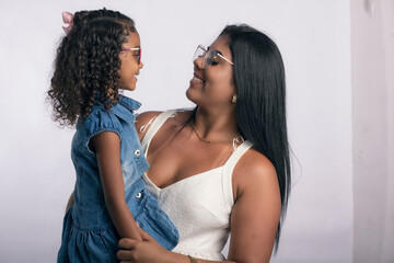 Young mother with daughter in photo studio on white background for clipping