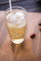 Chrysanthemum Juice, chilled, served in a clear glass placed on a black table