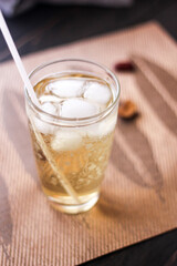Chrysanthemum Juice, chilled, served in a clear glass placed on a black table