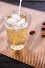 Chrysanthemum Juice, chilled, served in a clear glass placed on a black table