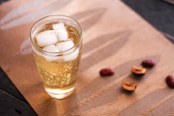 Chrysanthemum Juice, chilled, served in a clear glass placed on a black table
