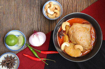 Thai food and Thai muslim food. Chicken Massaman curry with spices on old wood backgroud. Delicious Thai food. 
