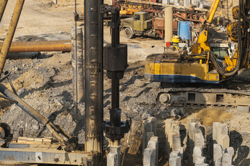 The pile driver hammers the pile.