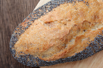 Crusty loaf of  bread on wooden background. rustic bread with seeds, Multi-grain bread with sesame.Organic food concept.