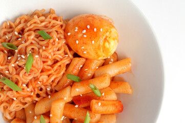Closeup of Tteokbokki or korean spicy rice cake and korean instant noodle in korean spicy sauce with boiled egg. Korean food style