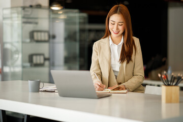 Confident business expert and Finance accounting concept, Portrait of an attractive Asian businesswoman at the office,