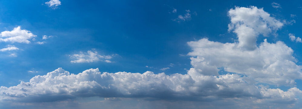 Panoramic photo of blue sky background with white clouds