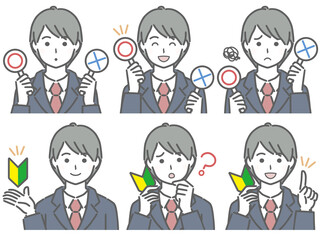 〇✕マークや初心者マークを持つスーツの若い男性