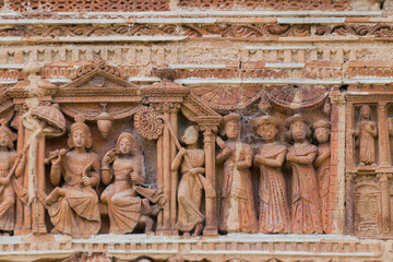 Terracotta decorations on the walls at Pratapeswar Temple at Kalna, West Bengal, India. Terracotta is a brownish-red clay that has been baked and is used for making things.