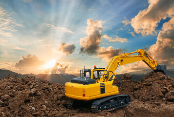 Side and back view of excavator  are digging soil in the construction site on sky and sunbeam background © chaphot