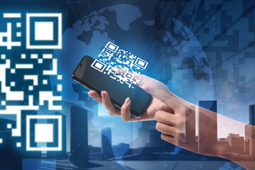 Double exposure of modern city and female hands holding smartphone with QR code on screen