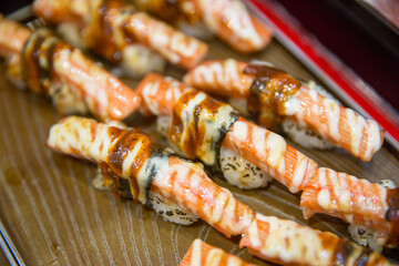 Top view of Sushi with crap stick Seaweed salad wakame and mayonnaise, focus selective.