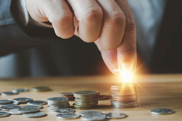 businessman coins stacking on desk with note for planning money finance.Saving money, saving money concept putting money coin stack growing business  concept.