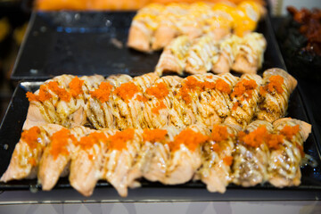 Sushi salmon burn Nigiri topping with shrimp egg, focus selective.