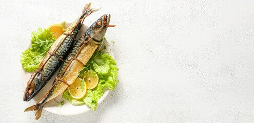 Plate with tasty smoked mackerel fish on light background with space for text