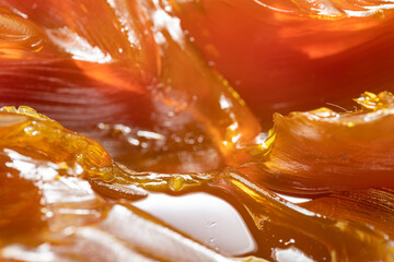 Close up of orange colored industrial grease. Rich and thick texture of industrial grade grease...