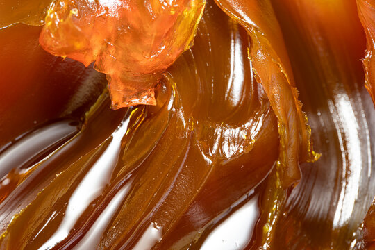 Close up of orange colored industrial grease. Rich and thick texture of industrial grade grease used to smooth out all metal friction. Lubricating grease. close-up of yellow lithium grease for machine