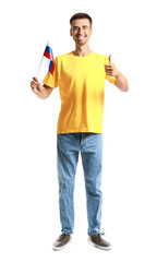 Happy young man with national flag of Russia showing thumb-up gesture on white background