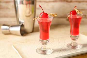 Plate with shot cocktails on color background, closeup