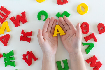 on human health. A phrase for health made up of multicolored plastic letters. The wish of health. Good wish. Wishing health to another. Yellow, green, red, blue. bright inscription made up by a child.