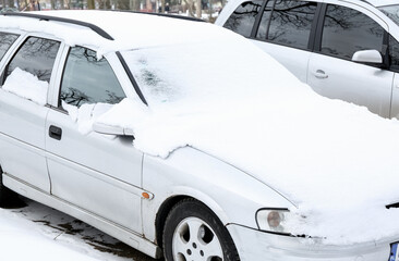 Fototapeta Car covered with snow on winter day obraz